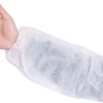 Disposable white sleeve cover worn on arm for protective hygiene in medical, food, or cleanroom environments.