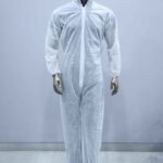 Disposable white PPE coverall suit with hood and shoe covers for safety and hygiene protection.