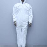A mannequin dressed in a full-body white disposable protective suit with a hood, standing on a metal base against a light blue wall and tiled floor.